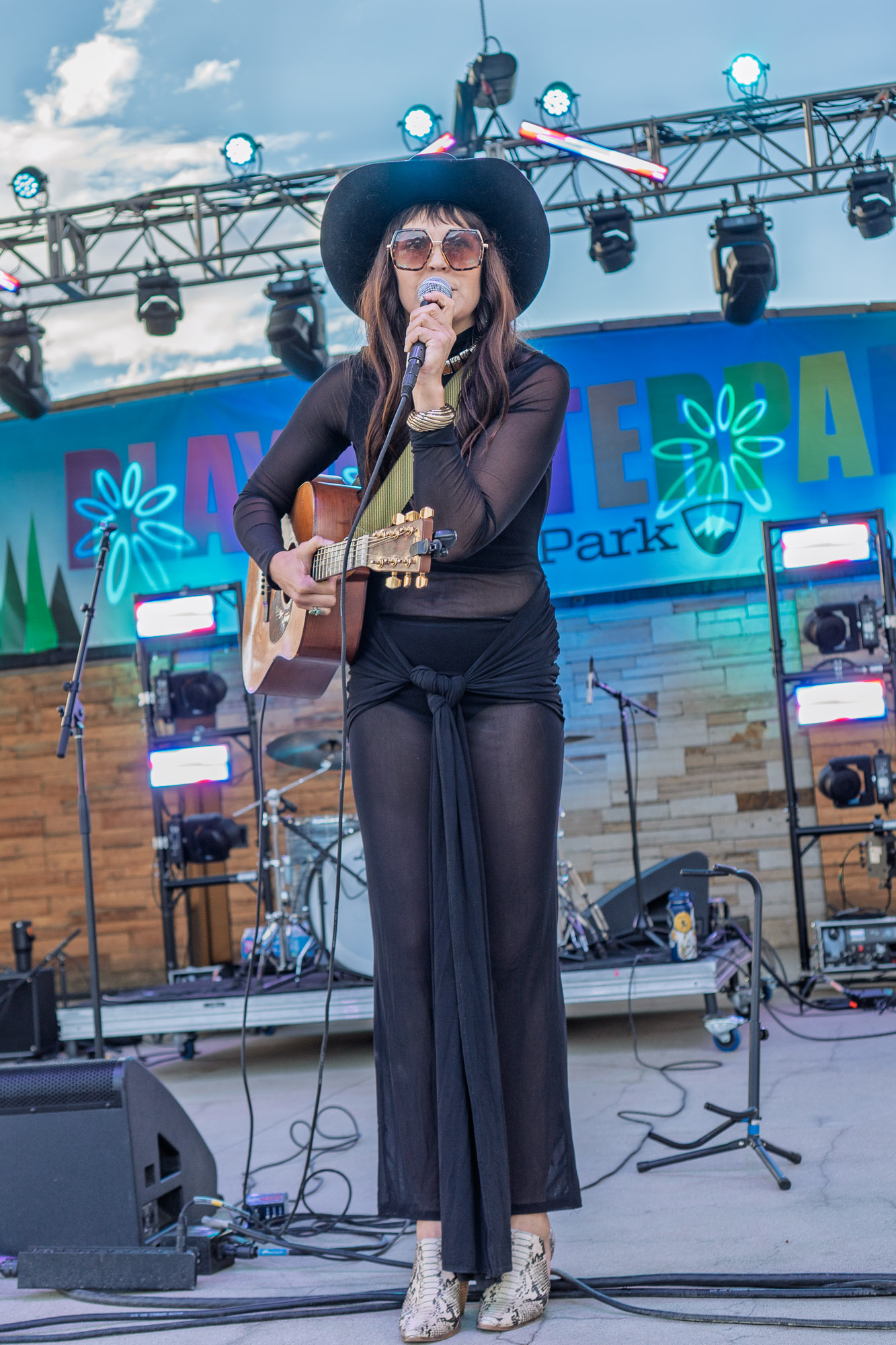 Rainy Eyes' vocalist sings at the microphone during High-Note Thursdays in Winter Park, Colorado