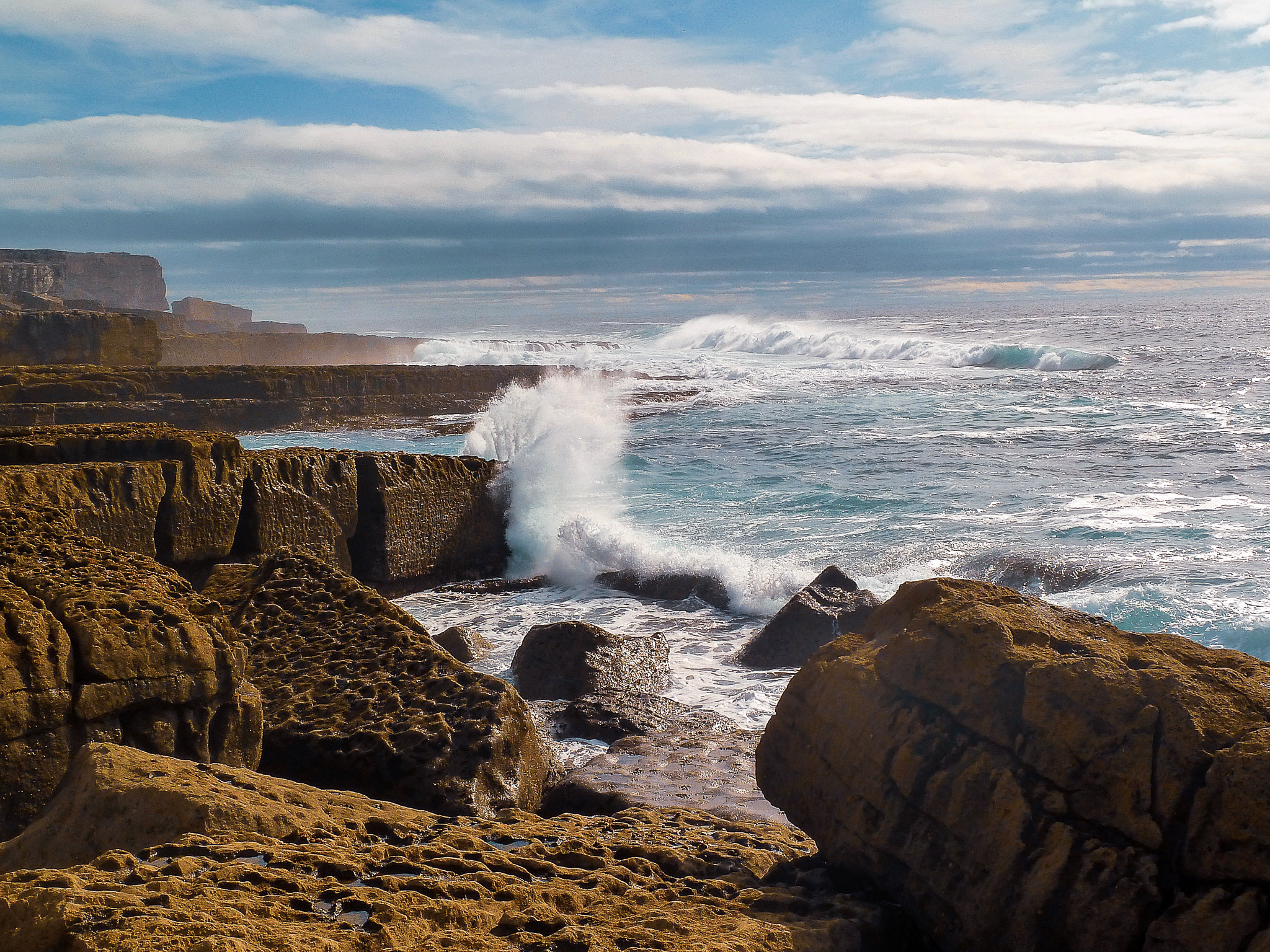 Retreat and hosted trip photographer — dramatic coastal wave crashing at an Irish shore during destination travel